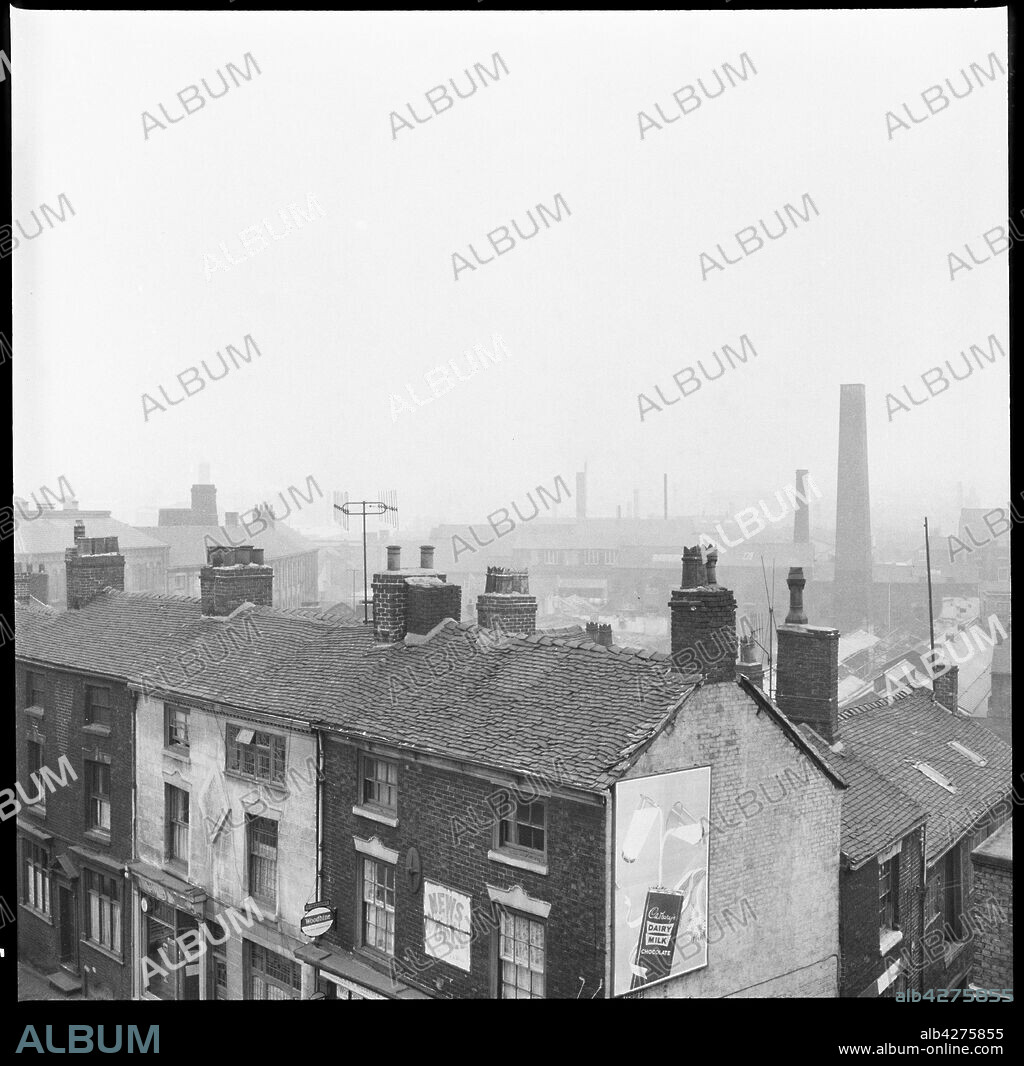 EILEEN DESTE. Nile Street, Burslem, Stoke-on-Trent, 1965-1968. An elevated view from a window of the George Hotel looking south with numbers 12-16 Nile Street and the entrance to Holecroft Street in the foreground and the Royal Doulton Works just visible in the background.