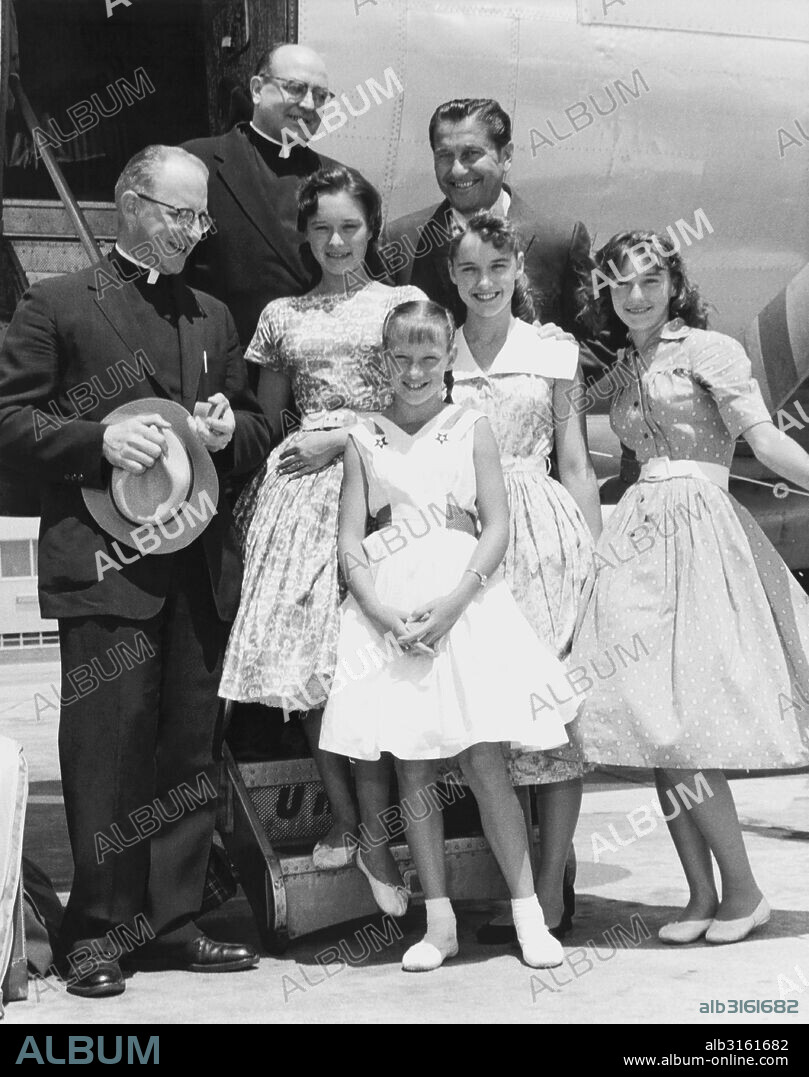 MIlwaukee, Wisconsin: June, 1958 Lawrence Welk (right, rear) and the Lennon Sisters are greeted by Marquette University Fathers M. G. Barnett and Adrian Kochanski upon their arrival there by plane.