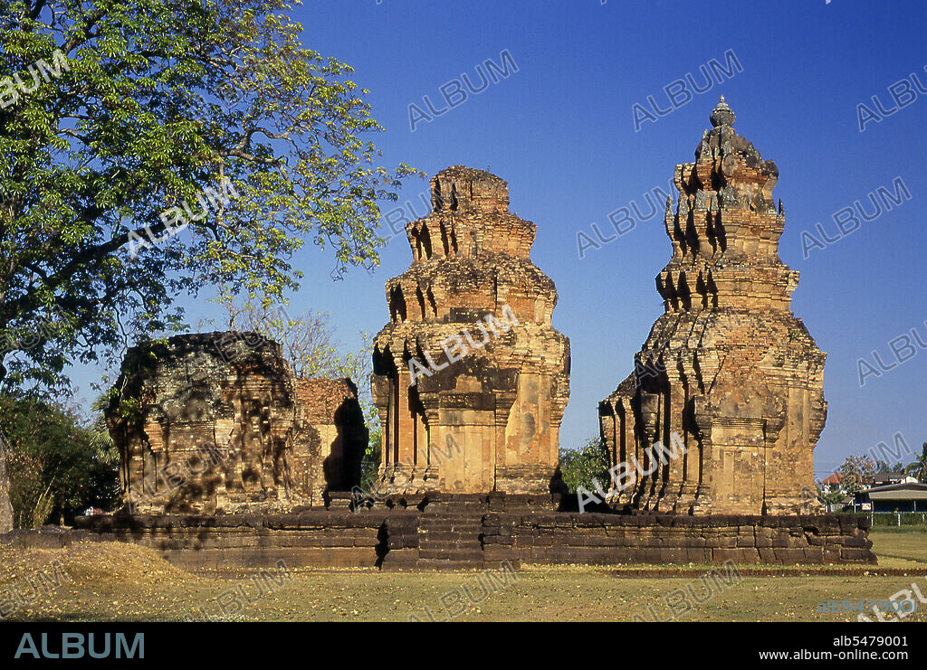 Prasat Sikhoraphum is a Khmer Hindu temple built in the 12th century by King Suryavarman II (r. 1113 - 1150). Prasat Sikhoraphum dates from the early 12th century and has been beautifully restored. It consists of five brick prangs on a square laterite platform surrounded by lily-filled ponds. The lintel and pillars of the central prang are beautifully carved with heavenly dancing girls, or apsara, and other scenes from Hindu mythology.