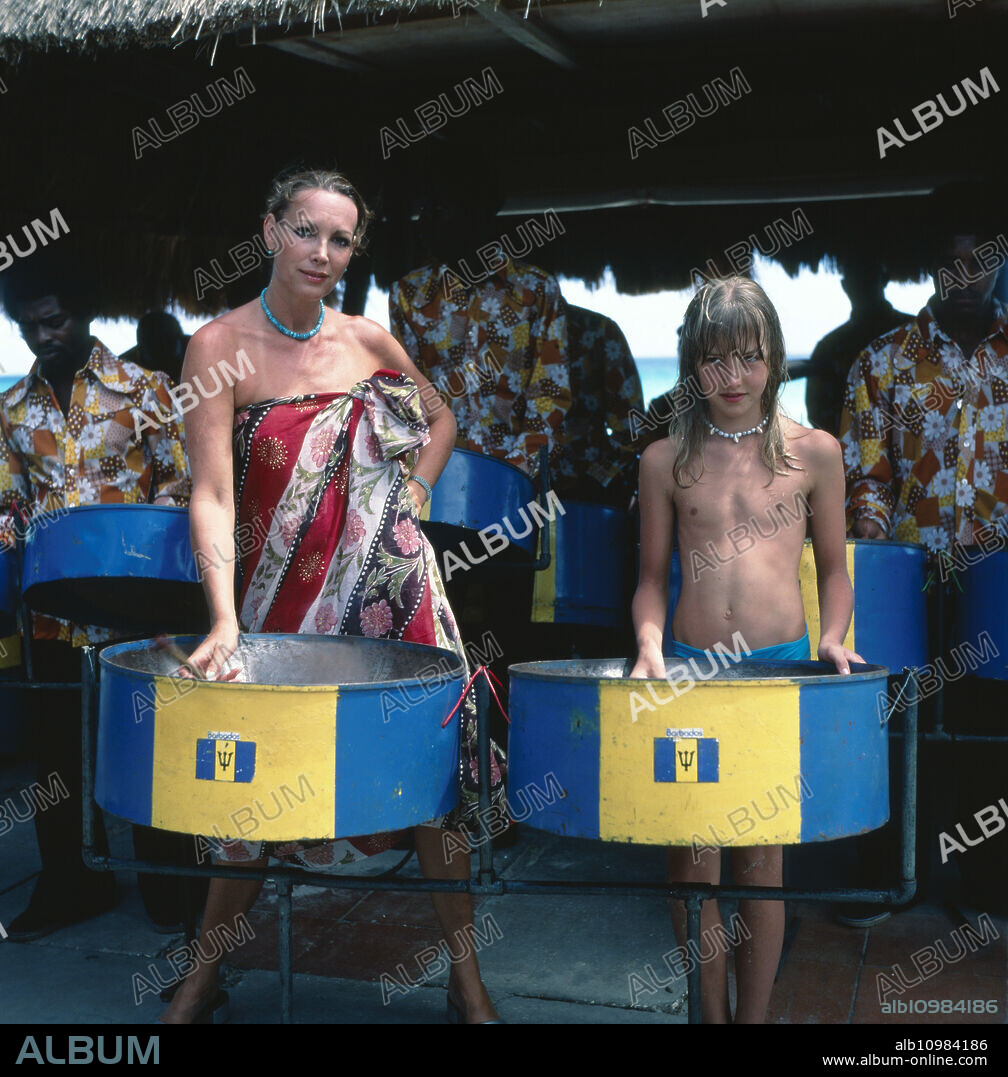 The German TV presenter, programme announcer, actress and former Miss World Petra Schürmann drums with locals and her daughter Alexandra Freund on vacation, circa 1978.