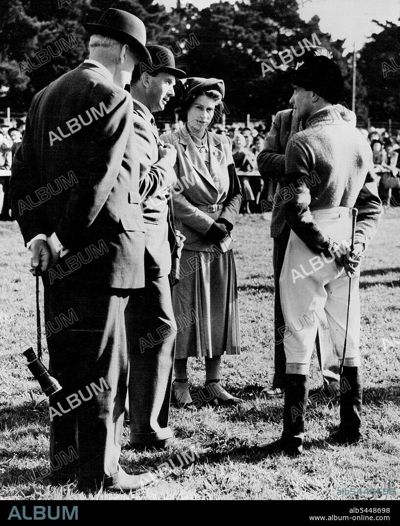 Princess Has A word With Her Jockey - Princess Elizabeth talking with her jockey A. Grantham, at Fontwell-Park today. Standing next to the Princess on left is Monaveen's trainer, Peter Cazalet. Princess Elizabeth was at Fontwell Park to-day (Monday) to watch Monaveen, the Grand National candidate which she owns in partnership with the Queen, win the Chichester Handicap Chase - his first outing in his new colours. Monaveen, ridden by A. Grantham, defeated Random Knight (second) and Mart in M (third ). The Princess had returned earlier in the day from Balmoral after the Royal Family's holiday. October 10, 1949. (Photo by Reuterphoto).