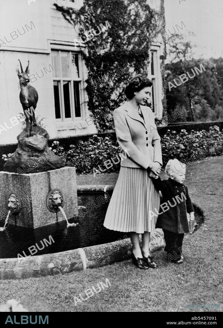 Posing For Prince Charles -- This new study of The Queen and Princess Anne, shows Her Majesty with her little daughter posing in the picturesque grounds of Balmoral Castle, for a photograph which is being taken by H.R.H. Prince Charles. May 01, 1953. (Photo by Fox Photos).