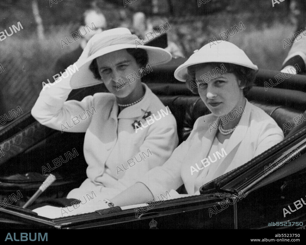 Royal Racegoers In The Ascot Breeze -- The Duchess of Kent puts a restraining hand to her hat, caught by the fresh broeeze, as she drives with her daughter Princess Alexandra down the course on their arrival at Ascot today (Tuesday). June 15, 1954. (Photo by Reuterphoto).