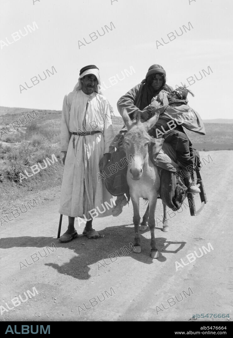 Bedouins in Israel, a woman and infant on donkey, a man standing ca. between 1934 and 1939.