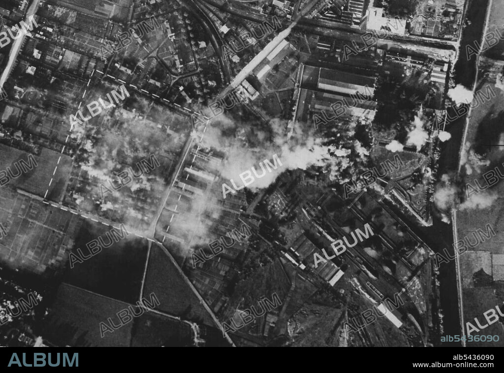 R.A.F. Daylight Attack on Comines -- Comines was attacked by bombers of the R.A.F. during a daylight seep on Northern France. The principal objective being the power station. Direct hits have been scored on the boiler house, pump near misses have caused damage. Workmen's houses in the marked rectangular area have direct hits. This photographer was taken a few seconds after No. C. 1924 by another. July 03, 1941. (Photo by British Official Photograph).