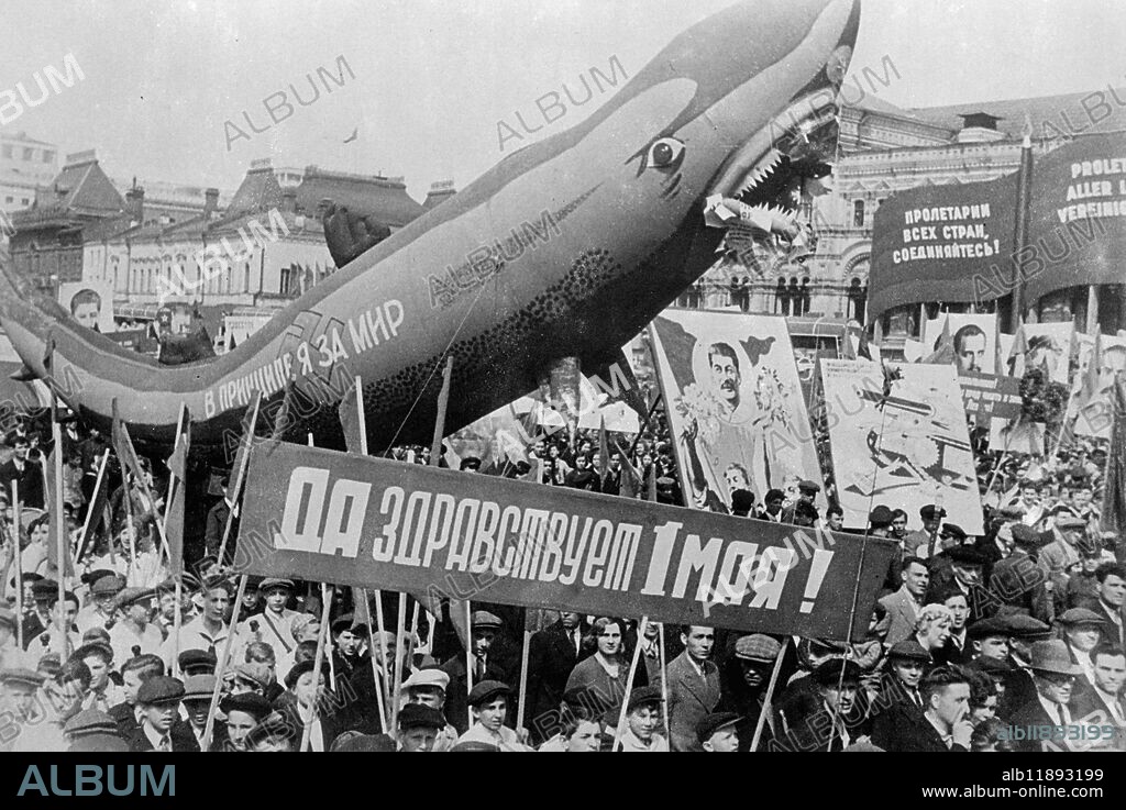 First pictures of May Day in Moscow . Fascist ' shark ' in great parade of civilians . Millions of civilions joined in a mass parade across Red Square when May Day cas celebrated in Moscow . the civilian parade followed the military parade in which tens of thousands of troops with the latest war machinery marched past Lenin ' s Tomb in honour of Stalin . Lord Marley was among the distinguished foreigners who watched the celebrations which this year had an even more light hearted note than usual in repsonse to Stalin ' s order that ' life is now gayer and better ' . Photo shows , a huge gas inflated shark in the civilian parade across Red Square . The shark represents ' belligerent fascism ' . Across the swastika are the words ' On principle , i am for peace ' . 5 May 1936.