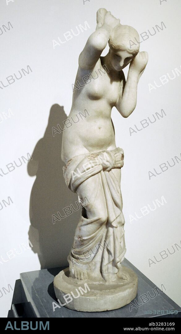 Marble statue of the Venus Anadiomene.  It represents the goddess that goes out of the bath. Venus in the Roman world was often identified with Isis and examples of this cult are found also in Egypt. Temple Isis. Pompeii. National Archaeological Museum, Naples. Italy.
