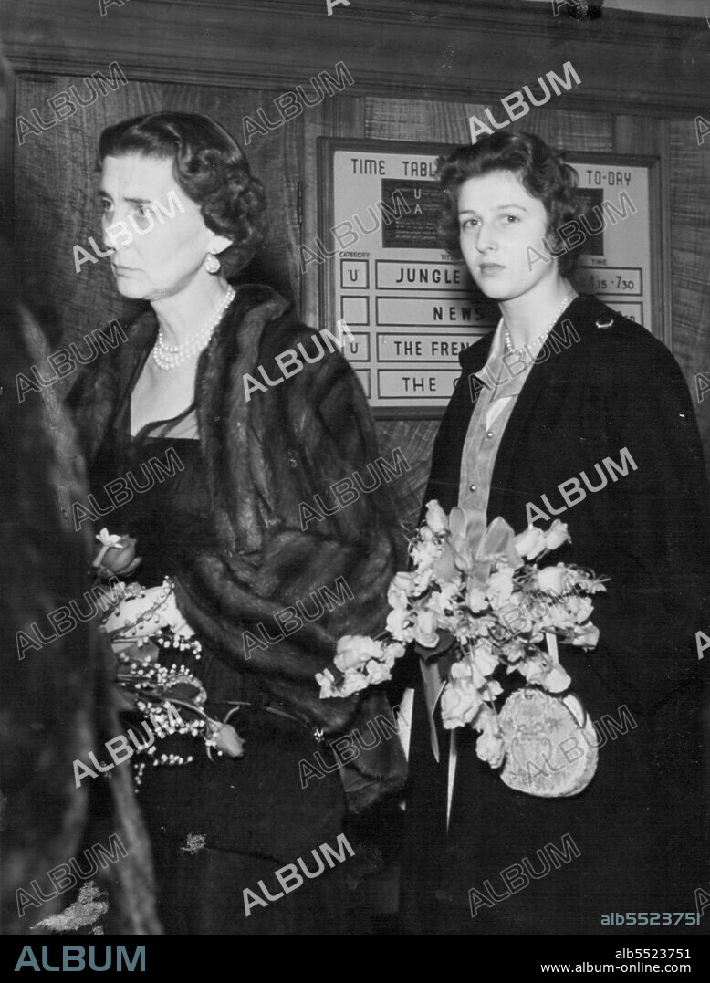 Royal Racegoers In The Ascot Breeze -- The Duchess of Kent puts a restraining hand to her hat, caught by the fresh broeeze, as she drives with her daughter Princess Alexandra down the course on their arrival at Ascot today (Tuesday). June 15, 1954. (Photo by Reuterphoto).