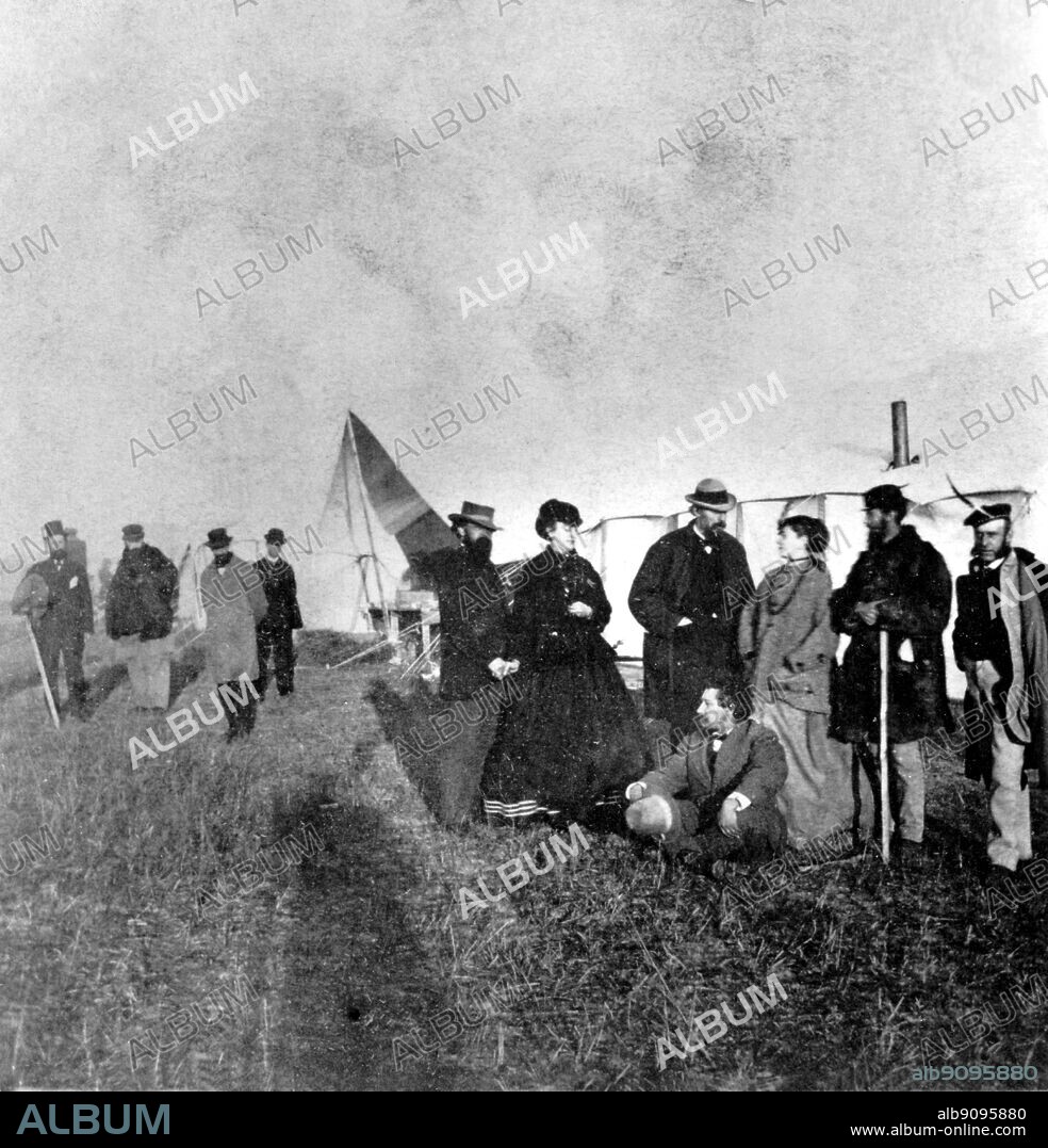 Excursionists photographed at Platte City headquarters, 25 October 1866, during excursion to 100th Meridian. Seated is George Francis Train, behind him Mrs Train and Thomas C Durant. George Francis Train (1829-1904) was a businessman and an eccentric figure in American history. Referring to himself as "Citizen Train", he was a shipping magnate, a prolific writer, a minor presidential candidate, and a confidante of French and Australian revolutionaries.