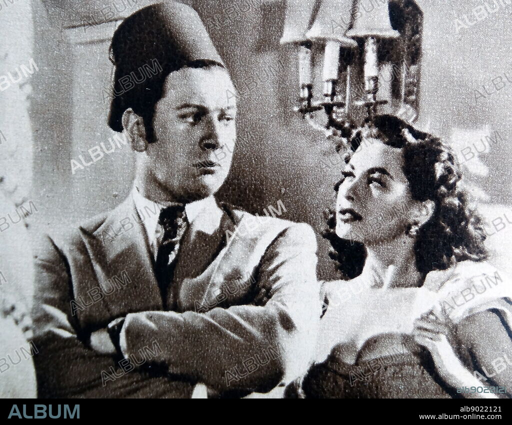 Peter Ustinov and Yvonne de Carlo in the film Hotel Sahara. Sir Peter Alexander von Ustinov CBE FRSA (16 April 1921 - 28 March 2004) was a British actor, filmmaker and writer. He was a fixture on television talk shows and lecture circuits for much of his career. An intellectual and diplomat, he held various academic posts and served as a goodwill ambassador for UNICEF and president of the World Federalist Movement. Margaret Yvonne Middleton (September 1, 1922 - January 8, 2007), known professionally as Yvonne De Carlo, was a Canadian-American actress, dancer, and singer. She became an internationally famous Hollywood film star in the 1940s and 50s, made several recordings, and later acted on television and stage.