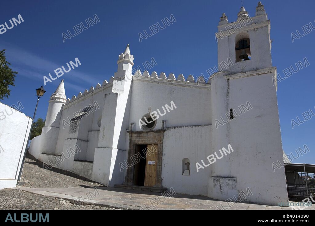 The main church (igreja matriz) of Mertola, Portugal, 2009. The most important monument of Mertola is its main church, originally a mosque, built between the 12th and 13th centuries. After the Christian conquest of the town, in 1238, the mosque was turned into a church, but its architectural structure was left unaltered. In the 16th century the church was partially remodelled, gaining Manueline vaulting with a new roof and a new main portal in Renaissance style. Nevertheless, the inner arrangement of the naves of the church, with four naves and several columns, strongly resembles that of the original mosque, and the interior of the church still has the mihrab, the decorated niche that indicates the direction of the Mecca. Outside, the church has four portals with horseshoe arches, typical of Islamic architecture.