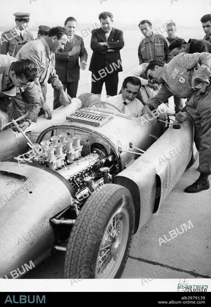 Alberto Ascari at the wheel of the new Lancia Grand Prix car, 1955. Enzo Ferrari signed Ascari up in 1949, and he won many races for Ferrari between 1950 and 1952. He was World Champion in 1952 and 1953. In 1952 he won every Grand Prix, and didn't lose a race until the middle of 1953. He performed the unrepeated feat of winning nine straight Grands Prix. He left Ferrari at the end of 1953 and on 1st January 1954 had signed for Lancia, who had designed and built an innovative new Grand Prix car, the Lancia D50, the first in their history.