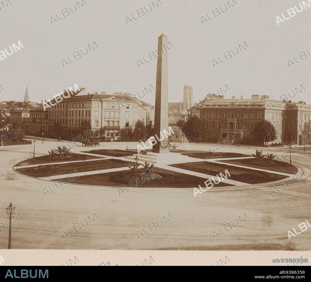 Obelisk, Karolinenplatz [?], Munich, Germany, View of square with traffic circle and obelisk in center, surrounding it a circular lawn with paths., anonymous, c. 1880 - c. 1910, photographic support, cardboard, height 200 mm, width 255 mmheight 510 mm, width 330 mm.