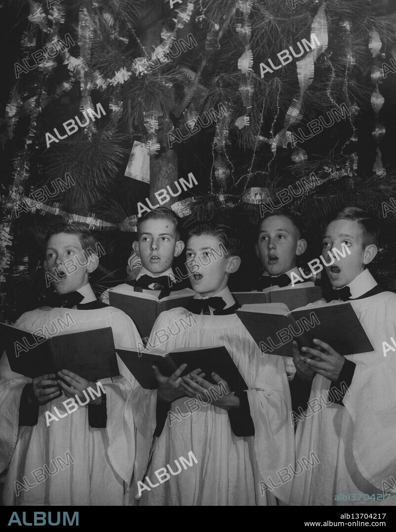 Members of the Sydney Boys Choir (the St. Andrew's Cathedral Choristers) today practiced Xmas music in the cathedral as they prepared for the two concerts which the choir will present tomorrow at the Town Hall - one at 2.30pm and the other at 8pm. (ie Tuesday). December 12, 1955. (Photo by Frank Albert Charles Burke/Fairfax Media).