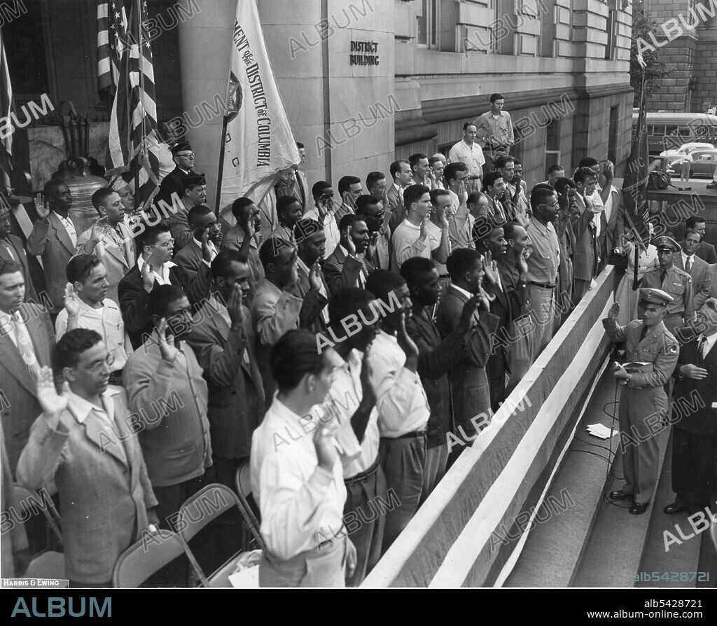 The first group of Washington, DC draftees since the beginning of the Korean conflict are sworn in at the District Building by Lt James F Schildt, Assistant Induction Officer for Washington, and Major General Lewis B Hershey, Selective Service Director, Washington, DC, 9/6/1950. (Photo by Harris & Ewing/PhotoQuest/Getty Images).