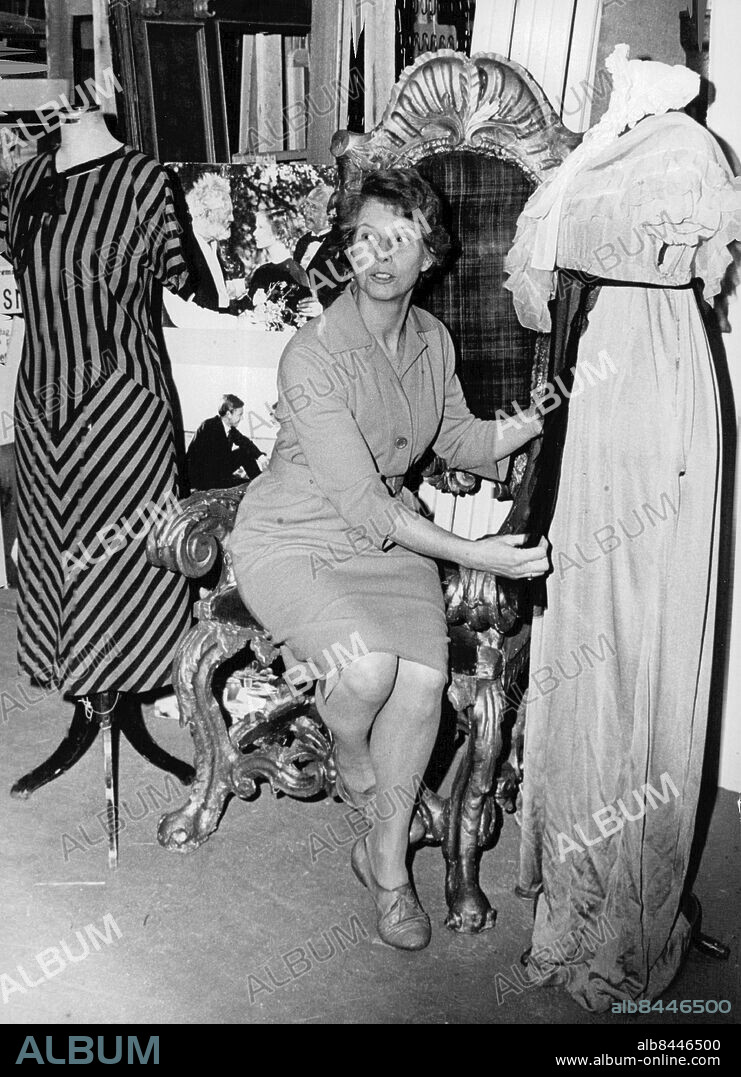 Stockholm 1965-12-07. Filmstaden i Råsunda. Fru Maj Erikson, ateljéchef för sömnad och klädvård visar en klänning som Greta Garbo bar som Elisabeth Dohna i "Gösta Berlings saga". Den randiga klänningen till vänster har burits av Ingrid Bergman i "Munkbrogreven". Foto: Jan Björsell / SvD / TT / kod 12014.