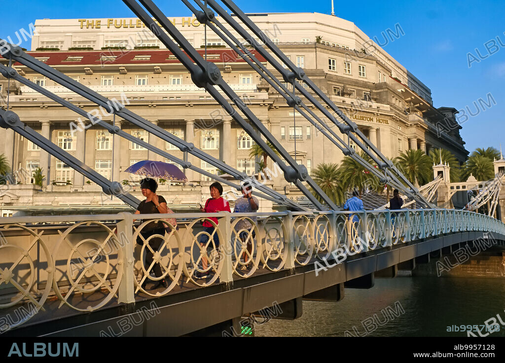 Singapore: Cavenagh Bridge over the Singapore River, with the Fullerton Hotel in the background. Cavenagh Bridge is one of the oldest bridges in Singapore, and spans the Singapore River. It was opened in 1869. The Fullerton Hotel is named after Robert Fullerton, the first Governor of the Straits Settlements.