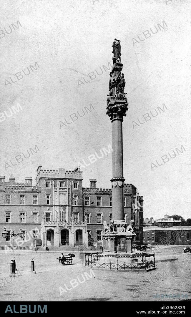 Westminster School War Memorial, Westminster, London.This carved granite column, with a figure on the top, by Sir George Gilbert Scott in 1859-61, is to the memory of members of Westminster School who died in the Crimean War and in India. It stands in front of the School in Broad Sanctuary. A trader is selling from a barrow near the memorial.