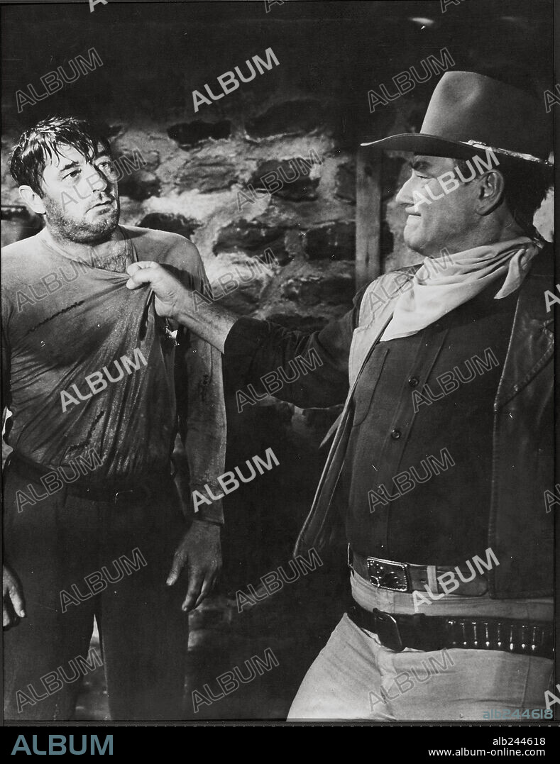 JOHN WAYNE and ROBERT MITCHUM in EL DORADO, 1966, directed by HOWARD HAWKS. Copyright PARAMOUNT PICTURES.