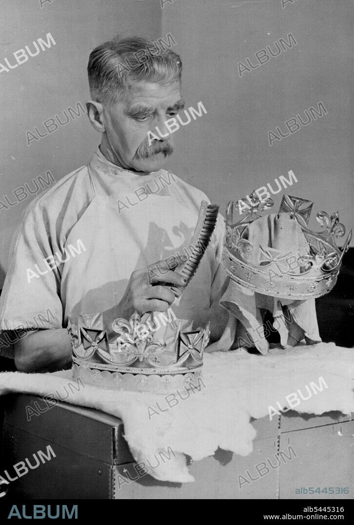 Coronets of British Princess To Be Shown At World Fair -- Mr. R. Holland who has been with Messrs. Garrard for 50 years, cleaning the old coronets --- from which those of the little Princesses were made this morning, April 26, at this firm's workshop. The Coronets worn by Princesses Elizabeth and Margaret Rose at the Coronation of their parents, king George VI and Queen Elizabeth, are to be on exhibition at the New York fair this summer. The coronets are replicas of two older coronets, now in the care of the crown jewellers, Messs. Garrard, of London. May 08, 1939. (Photo by Associated Press Photo).
