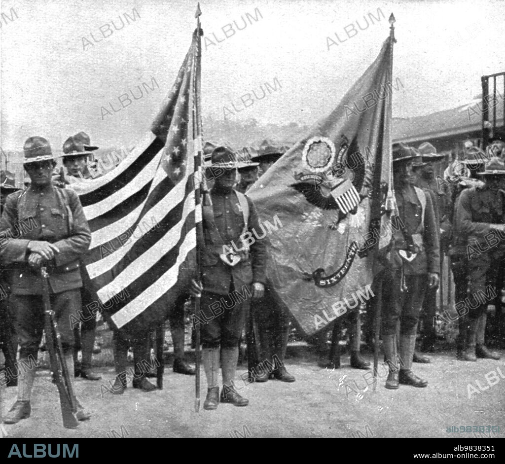 JEAN CLAIR-GUYOT. 'L'Installation en France de L'Avant-Garde Americaine; Les deux drapeaux du 16th d'infanterie americain', 1917. First World War: the American advance guard arrives in France; the two flags of the 16th US Infantry. From "L'Album de la Guerre 1914-1919, Volume 2" [L'Illustration, Paris, 1924].
