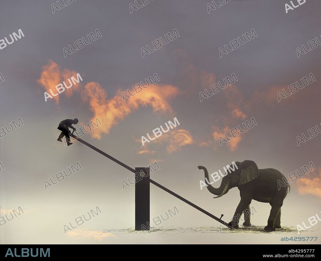 Man suspended in mid-air by elephant on seesaw.