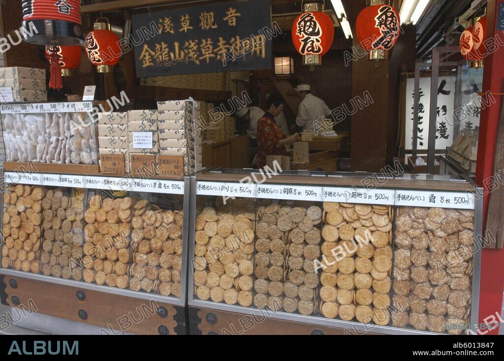 JAPAN Honshu Tokyo Asakusa. Nakamise-dori leading to Senso-ji temple a traditional "Sembei" grilled rice cracker shop displays wares.