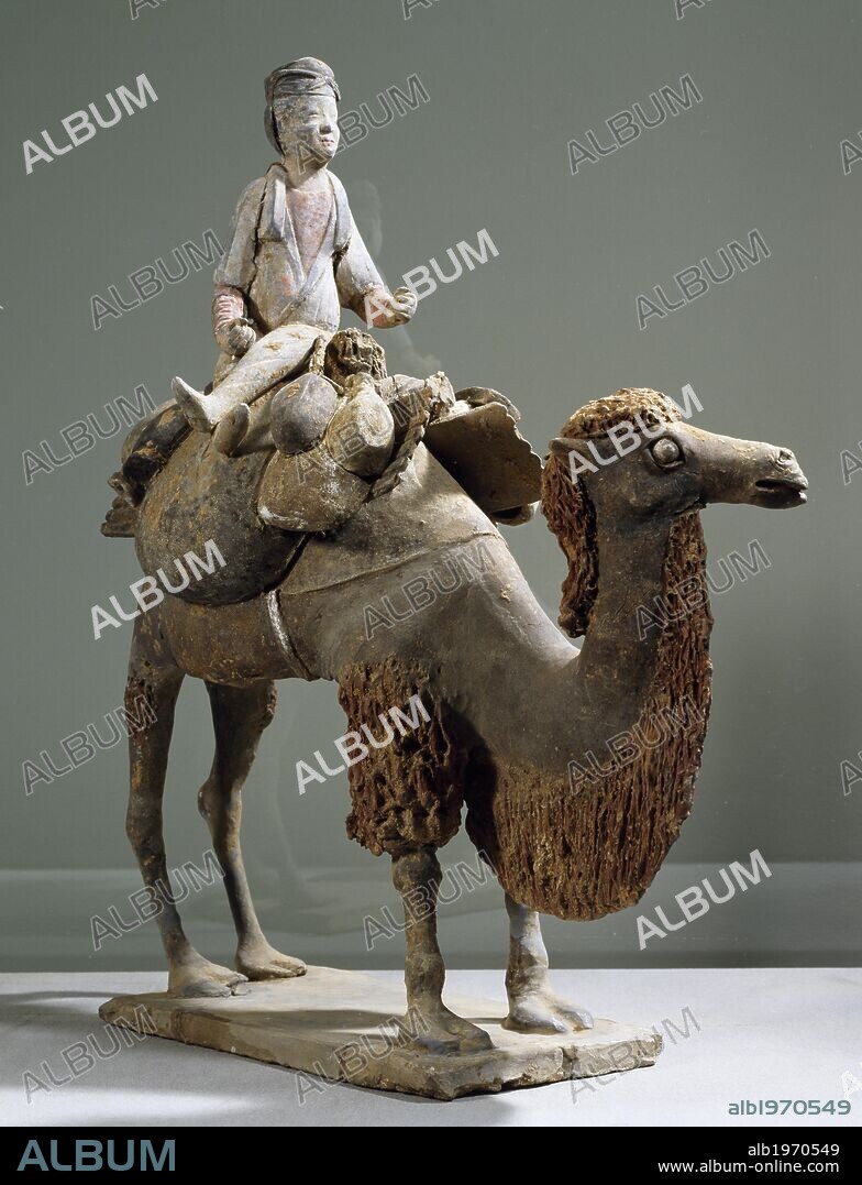 Figurine of camel rider on a camel, polychrome terracotta statue from Northern China, 43x36 cm. Chinese Civilisation, Tang Dynasty, 7th century.