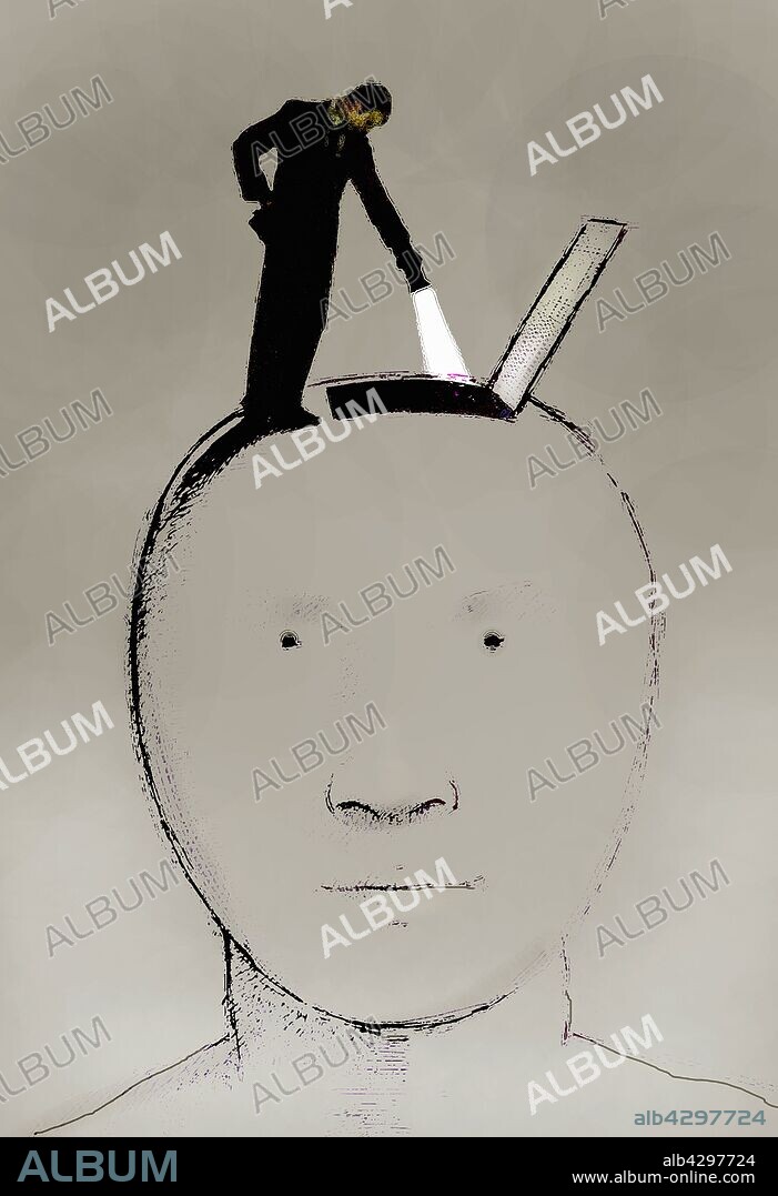 Man with flashlight looking into large head.