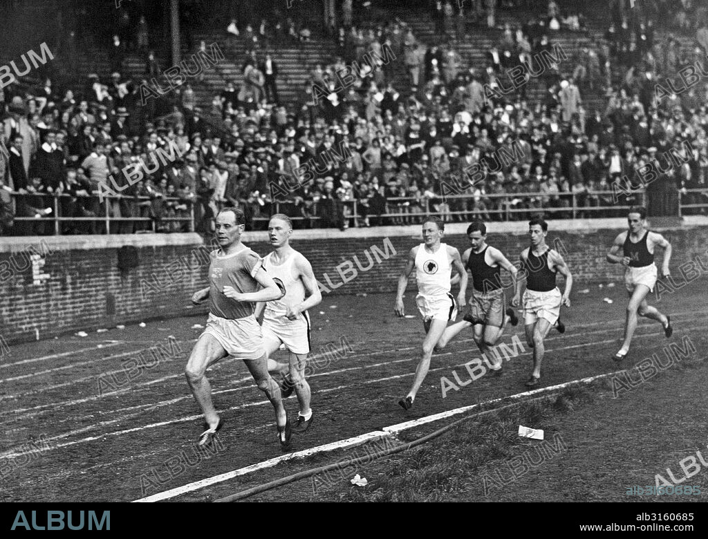 Philadelphia, Pennsylvania:   1929 Finn Paavo Nurmi surges ahead into the lead on his way to setting a new world's record in the two mile run at the Penn Relay Carnival held at Franklin Field at the University of Pennsylvania.