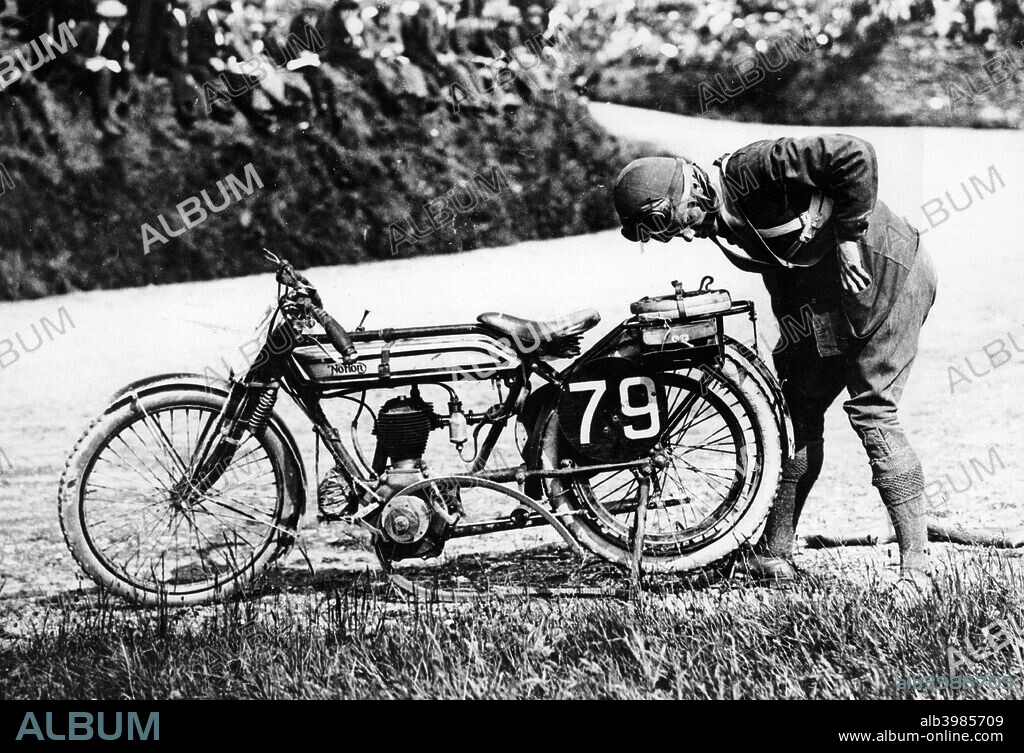 Norman Black repairing a punture on his Norton bike, 1920. This was the last belt driven machine to finish a TT race.
