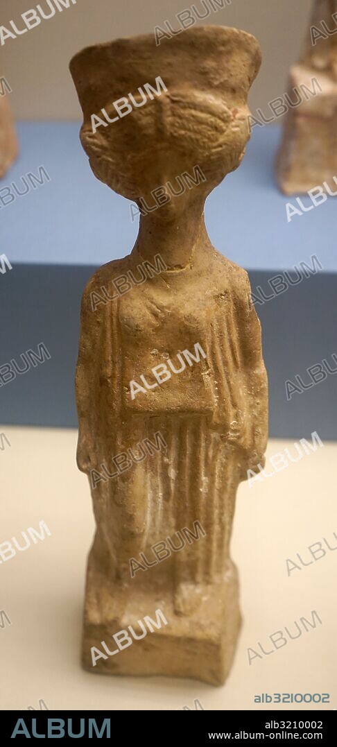 Terracotta figure of a woman wearing a Peplos and Polos crown. Dated 5th Century BC.