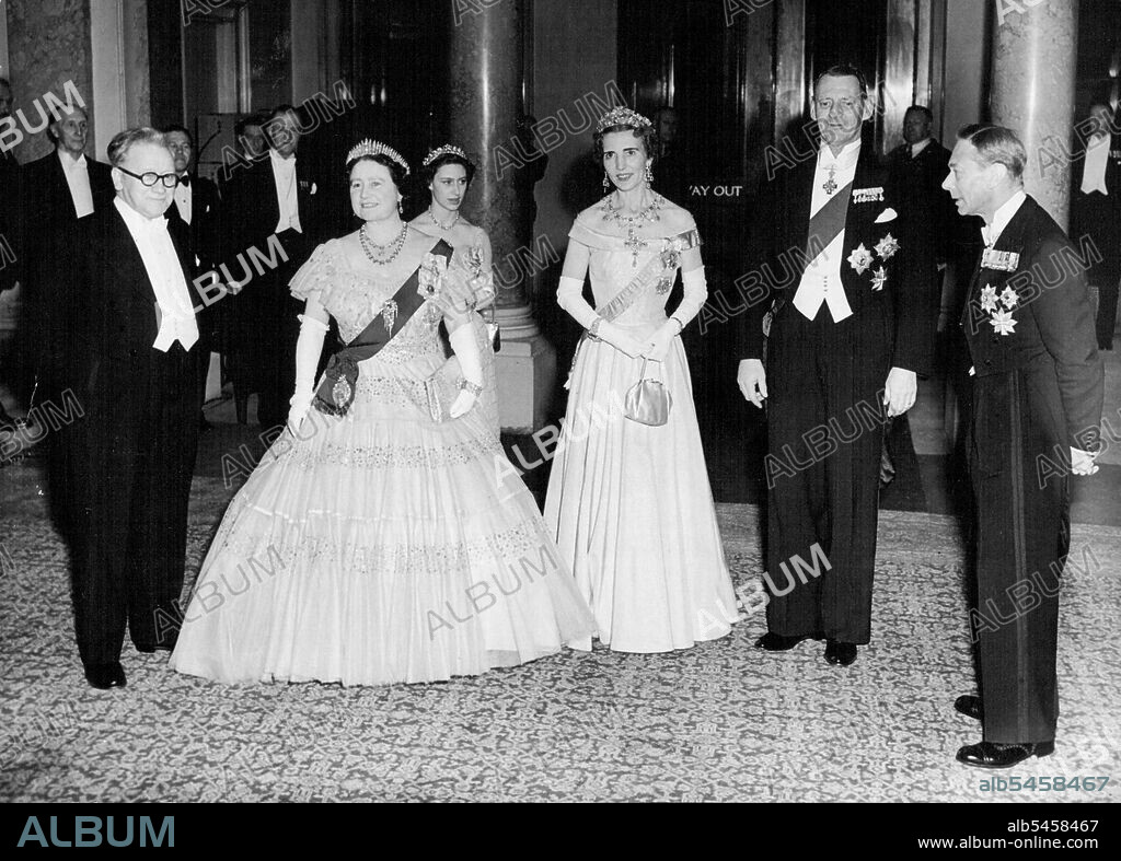 Photo Shows:- MR. Herbert (Lord Festival) Morrison (Britain's Foreign Minister), Britain's Queen Elizabeth, Queen Ingrid of Denmark, King Frederick of  Denmark, Britain's King George VI.Princess Margaret is Standing Behind the Queen .Danish And British Royalty at Government Reception:- Grand final to the visit of the Danish King and Queen was a Government Reception Held at Lancaster house, London Tonight. Members of the British Royal Family and the Government were Present. May 10, 1951. (Photo by Paul Popper).