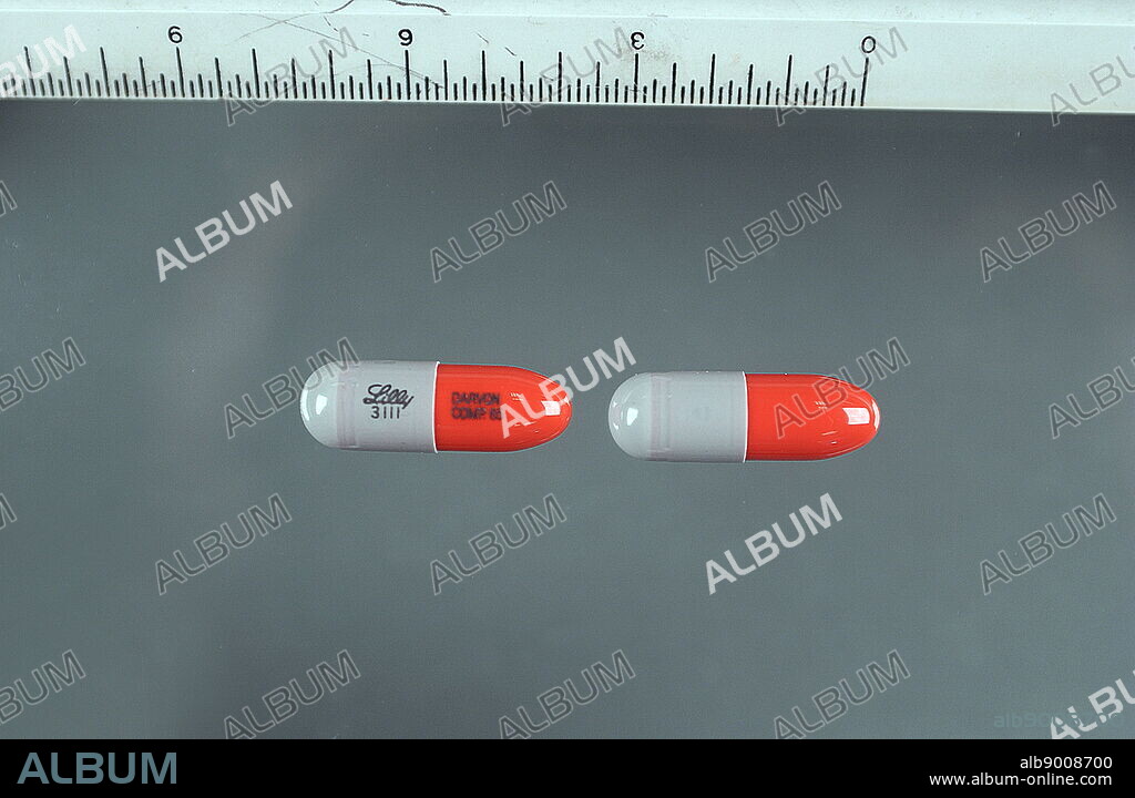 65 mg capsules of Darvon (Propoxyphene) a class of drugs called narcotic analgesics. It relieves pain. Aspirin is a less potent pain reliever, as well as an anti-inflammatory and a fever reducer.