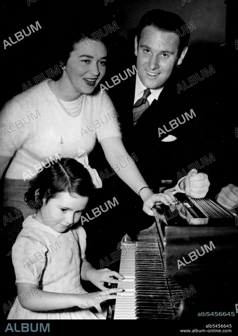 Rehearsal for Two - and Marita. Five-year-old Marita Bradley, daughter of well-known pianist Eunice Garland, accompaniste and associate artist for soprano Glenda Raymond in her Melbourne Town Hall concert tonight, imitated her mother while Glenda and baritone David Allen had last-minute rehearsal today. November 8, 1949.
