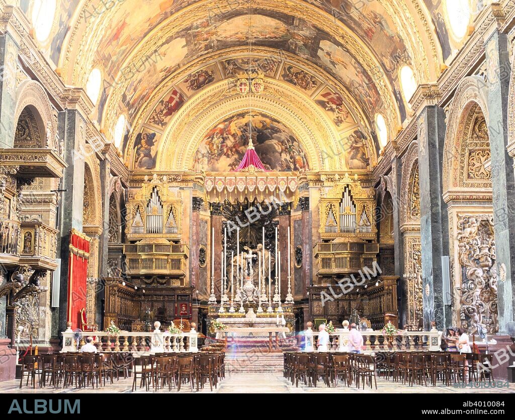 Interior of St John's Co-Cathedral, Valletta, Malta. St John's Co-Cathedral was built between 1573 and 1578 by the  Maltese architect Gerolamo Cassar. Originally the church of the Knights of St John, the co-cathedral came to rival the archbishop's cathedral at Mdina in importance. The ceiling and side altars are decorated with scenes from the life of St John, painted by the Calabrian artist Mattia Preti, and the building houses a small collection of paintings by Caravaggio.
