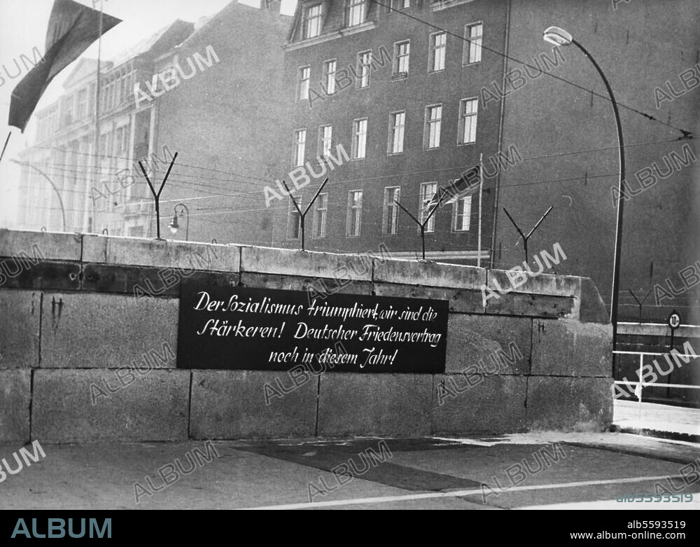 The Berlin Wall. (Building began on 13 August 1961). "Socialism is winning (...) ". A propaganda sign on the Wall in Chausseestrasse in the district of Wedding. Photo, October 1961.