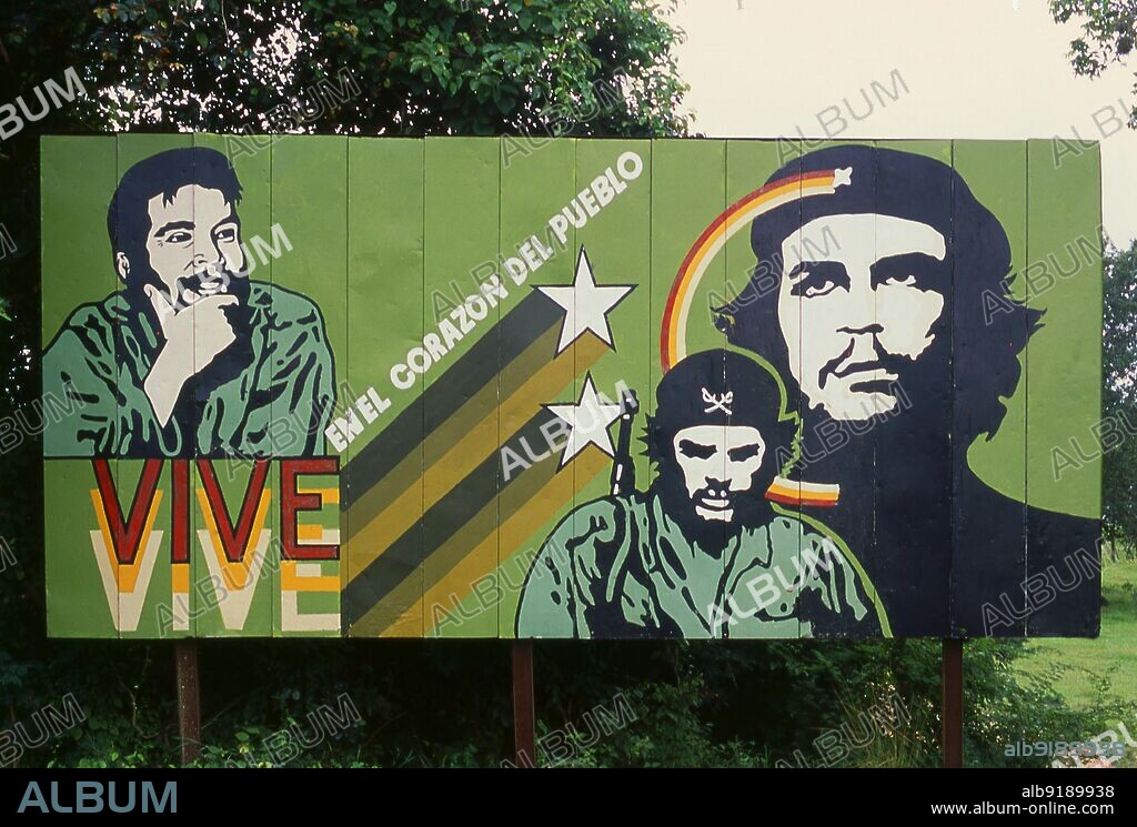 Cuba: 'He lives in the hearts of the people', a Che Guevara poster outside a small town in Matanzas Province. While living in Mexico City, Che Guevara (1928 - 1967) met Ral and Fidel Castro, joined their 26th of July Movement, and sailed to Cuba aboard the yacht, Granma, with the intention of overthrowing U.S.-backed Cuban dictator Fulgencio Batista. Guevara rose to prominence among the insurgents, was promoted to second-in-command, and played a pivotal role in the victorious two year guerrilla campaign that deposed the Batista regime.