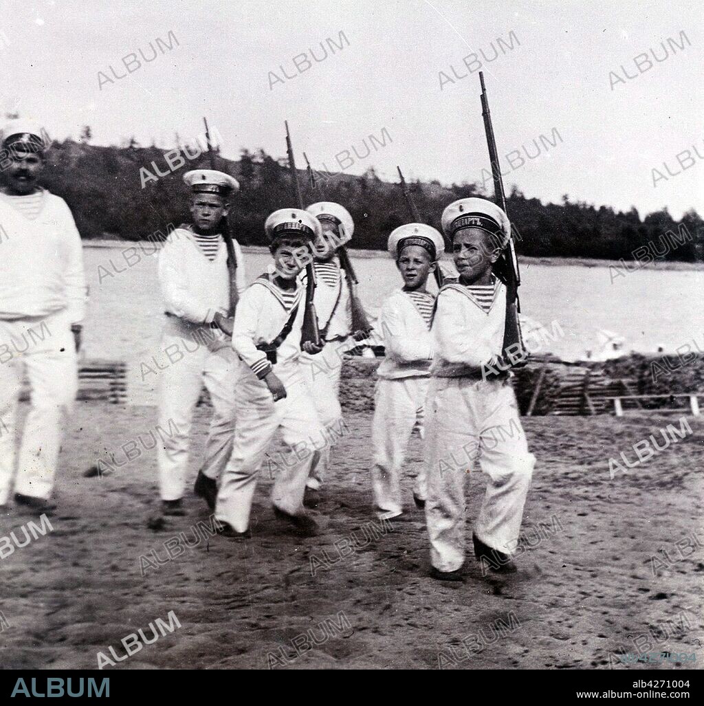 Klementy Nagorny (the sailor attendant) accompanies Alexei the Tsarevich (4th from right) as he plays with friends. Alexei Nikolaevich (1904 – 17 July 1918)  the Tsarevich of the Russian Empire. He was the youngest child and only son of Emperor Nicholas II and Empress Alexandra Feodorovna. He was born with haemophilia, his mother's reliance on the faith healer Grigori Rasputin to treat the disease helped bring about the end of the Romanov dynasty.