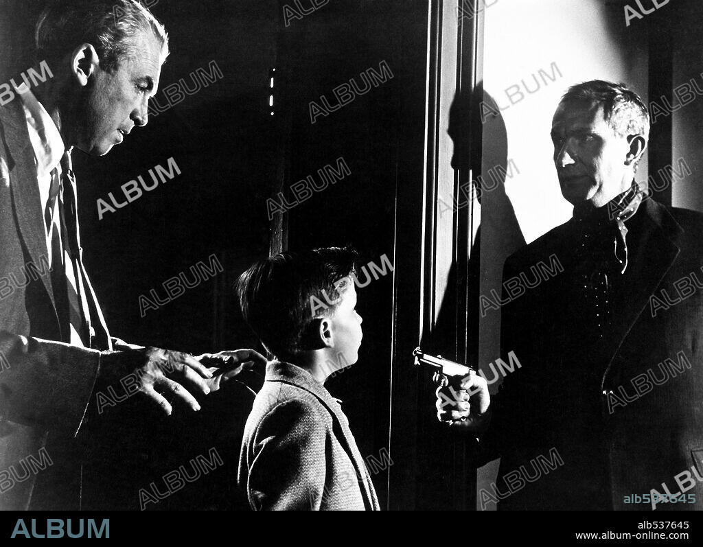 BERNARD MILES, CHRISTOPHER OLSEN and JAMES STEWART in THE MAN WHO KNEW TOO MUCH, 1956, directed by ALFRED HITCHCOCK. Copyright PARAMOUNT PICTURES.