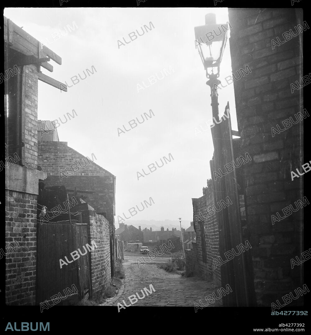 EILEEN DESTE. Short Street, Longton, Stoke-on-Trent, 1965-1968. A view looking south along Short Street with an old gas street lamp in the foreground and Normacot Road in the distance.