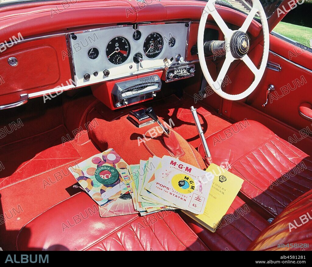 1960 Jaguar XK150 interior with record player and 7inch vinyl discs..