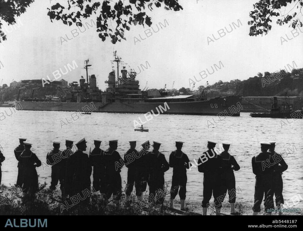 US Naval Visit to Stockholm -- The American cruiser anchored in the Stockholm Harbour, with a Swedish guard of honour in the foreground. The American cruiser "Baltimore" and the destroyer "Glennon", with 1600 men aboard. Have arrived in Stockholm for a six-day visit. August 24, 1954. (Photo by Paul Popperm Paul Popper Ltd.).