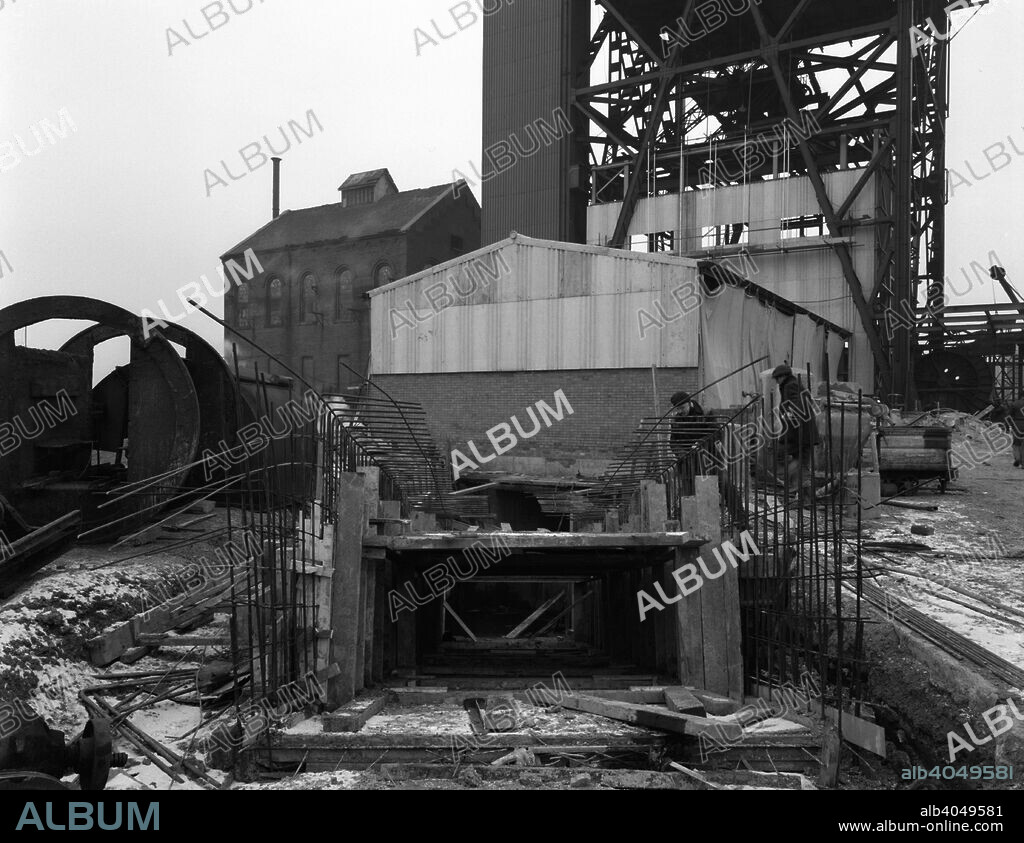 Refurbishment work, Mosley Common Colliery, Lancashire, 1963. Civil engineers at work securing the steel reinforcement on the substructure of the dirt conveyor during the refurbishment of Mosley Common Colliery. By the late 1950s, the colliery employed 3000, and was among the largest and most modern pits in the country. However it was closed in 1968 without having been exhausted, and the site was cleared by 1974.