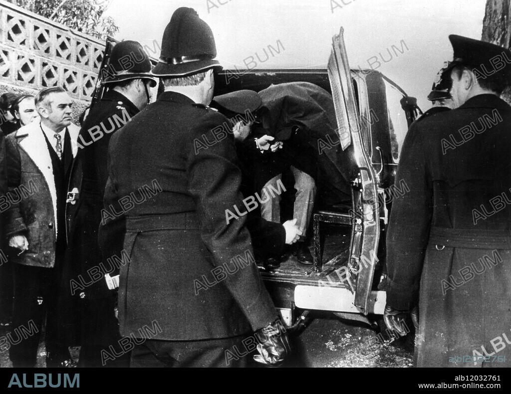 Photo shows: Paisnel being removed from van at his house when visited by court . Edward John Louis Paisnel (1925 - 1994), dubbed the Beast of Jersey, was a notorious sex offender who terrorised the Channel Island of Jersey for a period of eleven years from 1960. He entered homes at night dressed in a rubber mask and nail-studded wristlets, attacking women and children.
