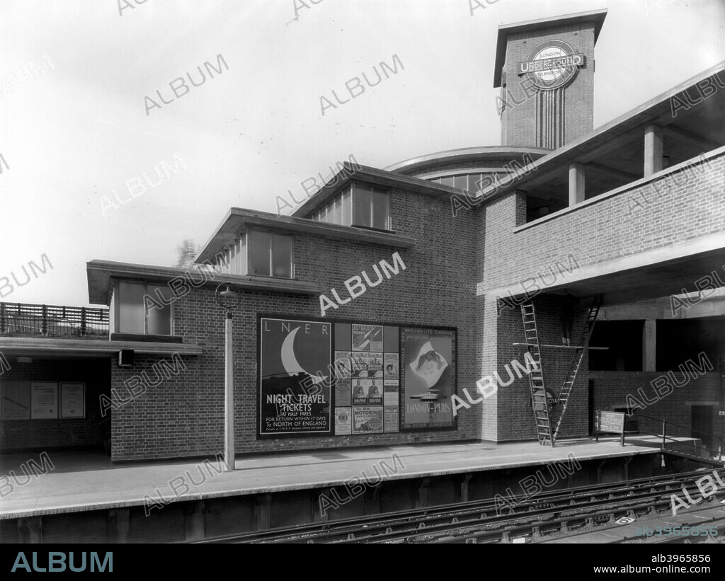 Park Royal Underground Station, Western Avenue, Ealing, London, c1936. Posters advertise sleeper services to Paris and the North of England. Park Royal Station was rebuilt in 1935-6 by Welch & Lander: the tower and circular booking hall (just visible) were features. It is probably photographed soon after completion.