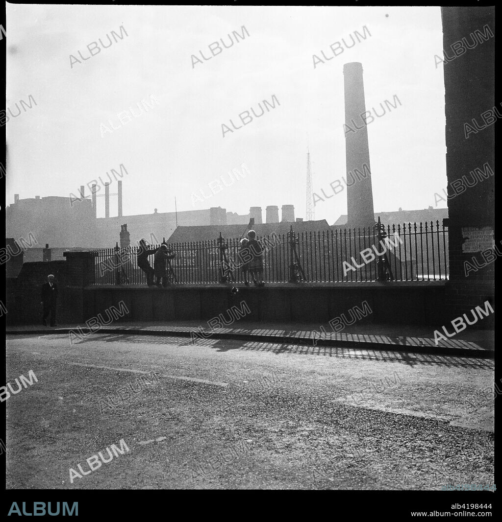 Westwood Mills, Lichfield Street, Hanley, Stoke-on-Trent, Staffordshire, 1965-1968. A group of children looking towards George Goodwin and Sons' Westwood Mills from the bridge carrying the A50 (Lichfield Street) over the Caldon Canal.