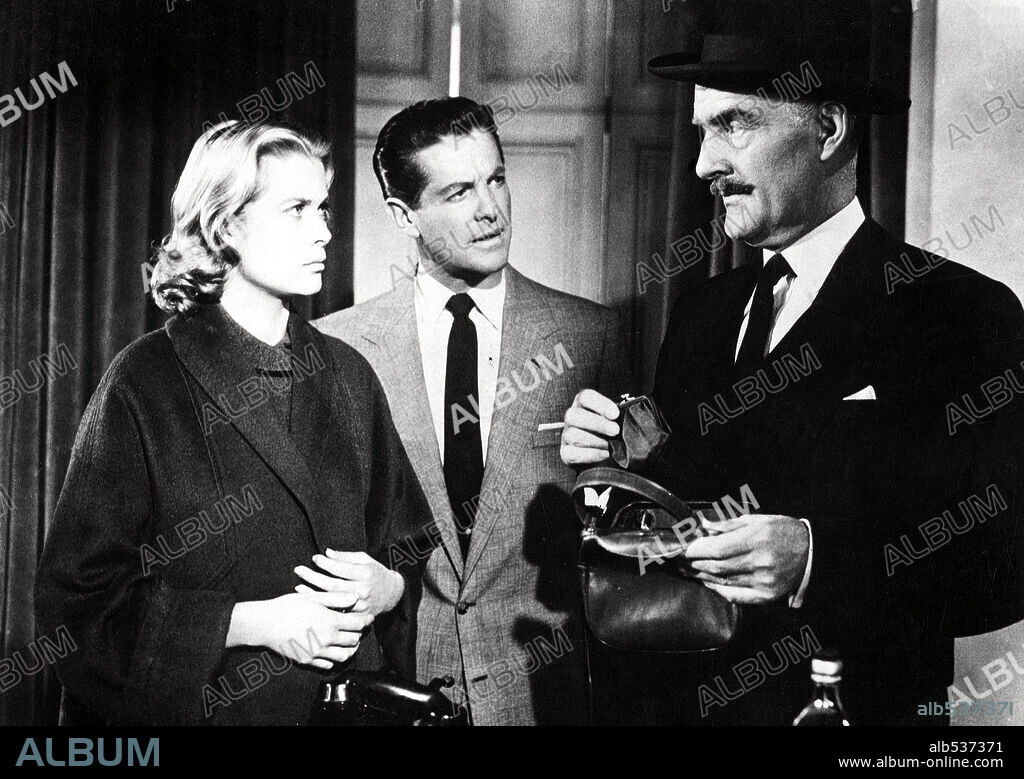 GRACE KELLY, JOHN WILLIAMS and ROBERT CUMMINGS in DIAL M FOR MURDER, 1954, directed by ALFRED HITCHCOCK. Copyright WARNER BROS.