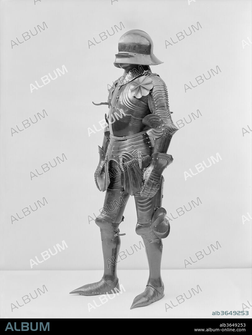 Gothic Armor. Culture: German and Italian. Dimensions: Wt. 54 lb. 7 oz. (24.7 kg); 29.150.8n (leg defense); H. 21 in. (53.5 cm); W. 7 in. (17.8 cm); D. 9 in. (22.9 cm); Wt. 3lb. 12.1 oz. (1703.8 g); 29.150.8q (greave); H. 16 1/8 in. (41 cm); W. 4 13/16 in. (12.2 cm); D. 5 3/8 in. (13.7 cm); Wt. 2 lb. 1.3 oz. (944 g); 29.150.8r (mail sleeve): L. 28 5/16 in. (72.0 cm); W. 12 5/8 in. (32.0 cm); Diam. (outside) of main section links 7/32 in. (5.5 mm); Diam. (inside) of main section links 5/32 in. (4.7 mm); Diam. (outside) of cuff links 3/16 in. (4.4 mm); Diam. (inside) of cuff links 3/32 (2.5 mm); 29.150.8s (mail sleeve): L. 32 1/8 in. (81.5 cm); W. 15 in. (38.0 cm); Diam. (outside) of links 7/32 in. (5.9 mm); Diam. (inside) of links 5/32 (3.7 mm). Date: late 15th century; extensively restored and completed ca. 1926.
From the early nineteenth century through about the mid-twentieth century, it was not unusual to restore incomplete armor by combining elements from different armors, making missing pieces out of modern or reused old metal and decorating or redecorating pieces to match as needed. With objects in the Metropolitan Museum's collection, founding curator of the Arms and Armor Department Bashford Dean took a conservative approach for his day, having his armorers make, add to, or alter only those pieces he considered absolutely necessary to create an exhibitable display. In addition, the work done on the Museum's pieces was usually signed and dated. For his private collection, however, Dean sometimes took a more liberal approach, delighting in composing armors out of disparate parts, augmented by whatever newly made or repurposed pieces were required to complete the ensemble he had in mind.
In this instance, Dean's goal was to create a late German Gothic armor, a type often considered the pinnacle of armor-making. Complete and homogeneous examples were nonexistent on the art market by Dean's time. Taking a superb late fifteenth-century helmet by the Landshut armorer Matthes Deutsch, and a nucleus of genuine torso, arm, and leg pieces, Dean's craftsmen made this truly impressive and historically accurate representation of a German Gothic armor. As a result, about fifty percent of it is restoration. The plates are not signed, but we know from letters written at the time that some of the work was done by Leonard Hugel (1877-about 1935) and Harvey Murton (1907-2004) in about 1926. However, because of the extent of the restorations, only the helmet is regularly on permanent display today.