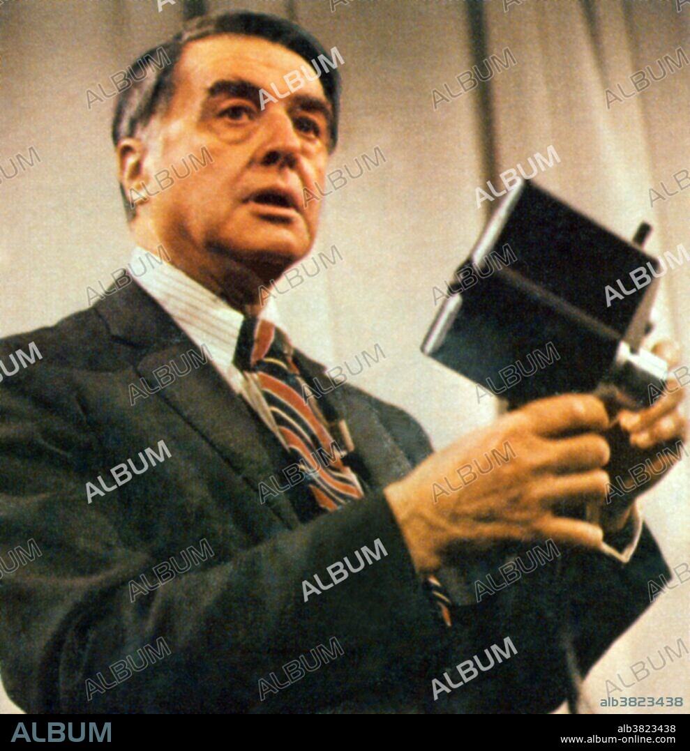 Land reveals his latest camera and cassette: movies in 90 seconds. May 9, 1977. Edwin Herbert Land (1909-1991) was an American scientist and inventor, best known as the co-founder of the Polaroid Corporation. Among other things, he invented inexpensive filters for polarizing light, a practical system of in-camera instant photography, and his retinex theory of color vision. His Polaroid instant camera, which went on sale in late 1948, made it possible for a picture to be taken and developed in 60 seconds or less. Land died on March 1, 1991 at the age of 81. Upon his death, his personal assistant shredded his personal papers and notes.